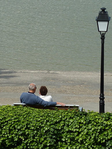 Lovers sitting on a bench in the Bay of Somme