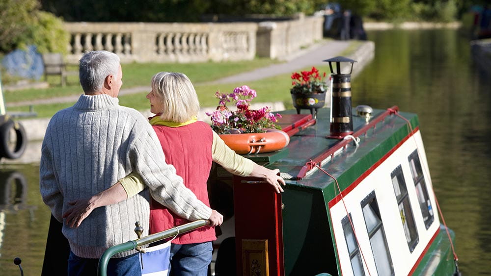 Couple hugging on a narrow boat
