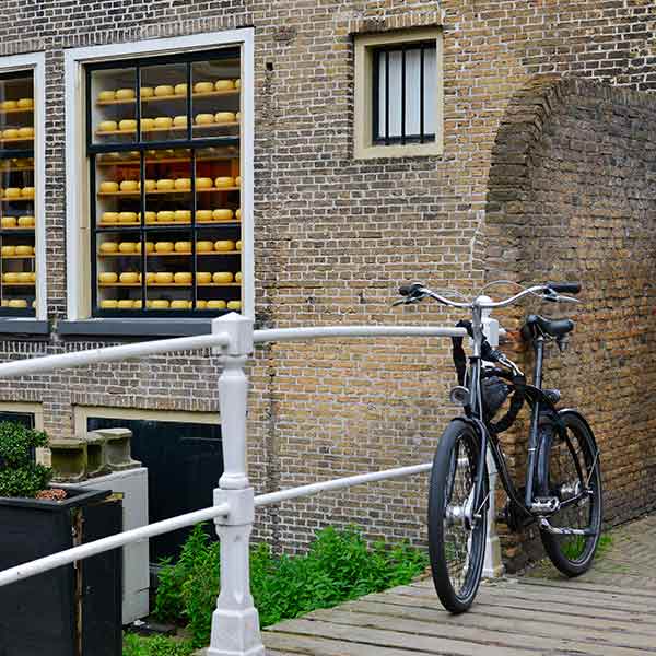 Bike on a bridge with old brickwork in Delft