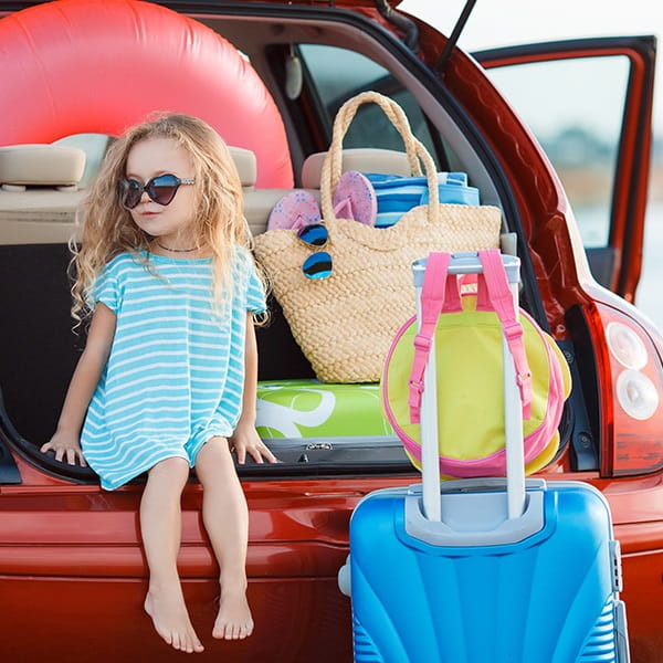Child With Luggage In Car