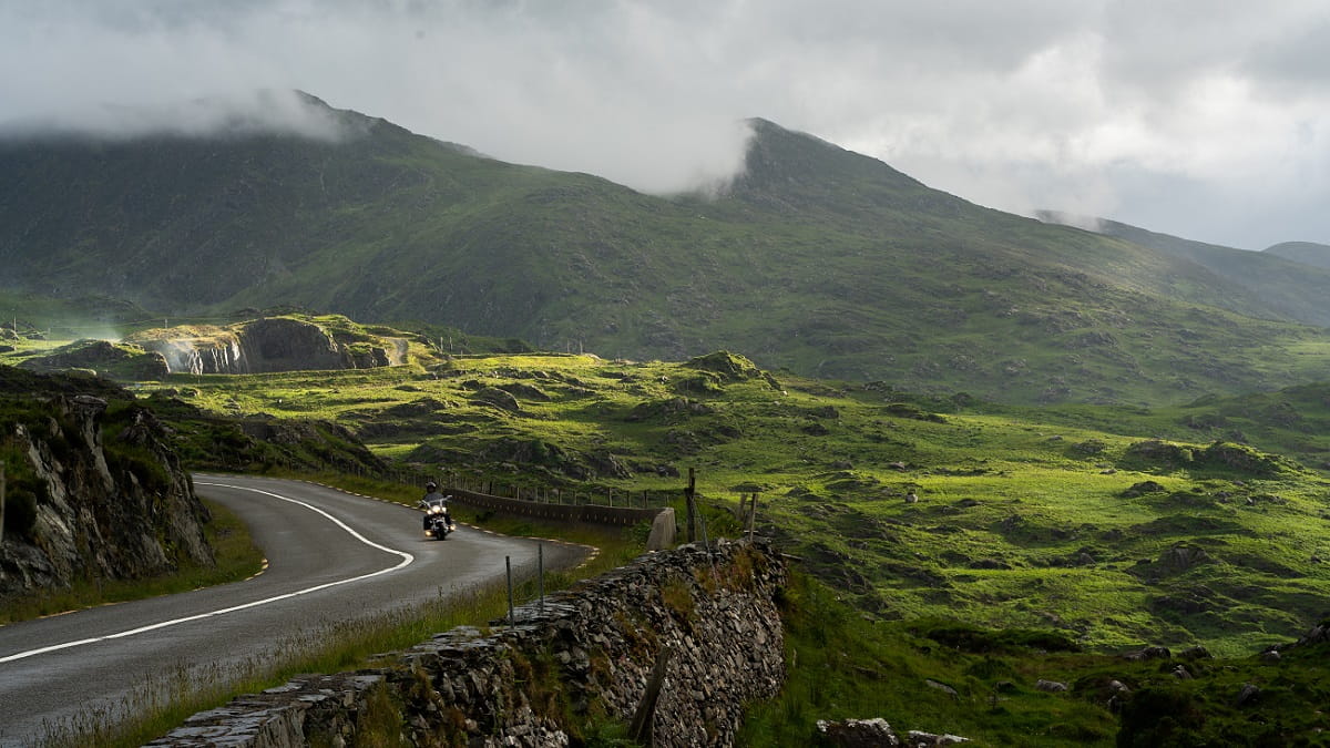 Man travelling to Ireland on a motorbike through hills